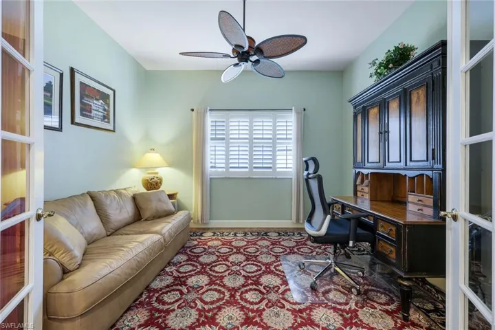 Home office featuring ceiling fan and french doors