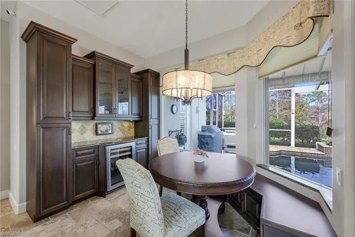 Dining space with an inviting chandelier and beverage cooler