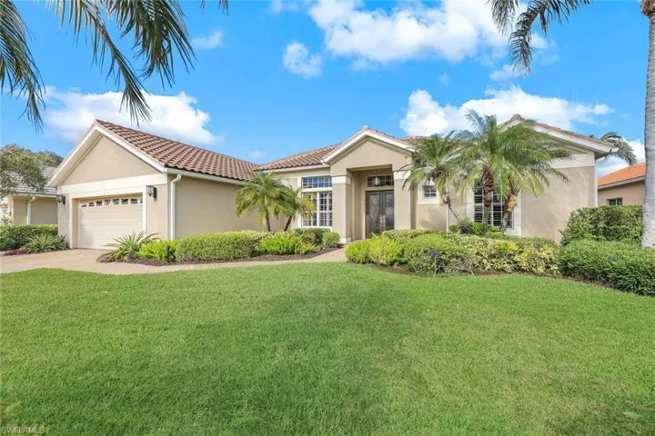 Mediterranean / spanish house featuring a garage and a front yard