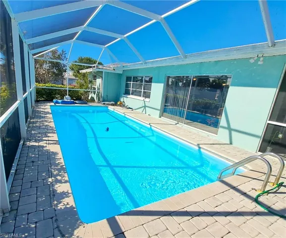 Swimming pool with a lanai and a patio area