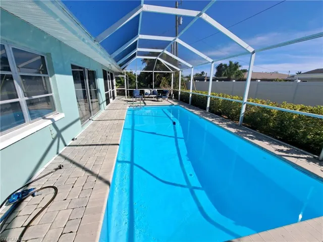 View of swimming pool with a patio and a lanai