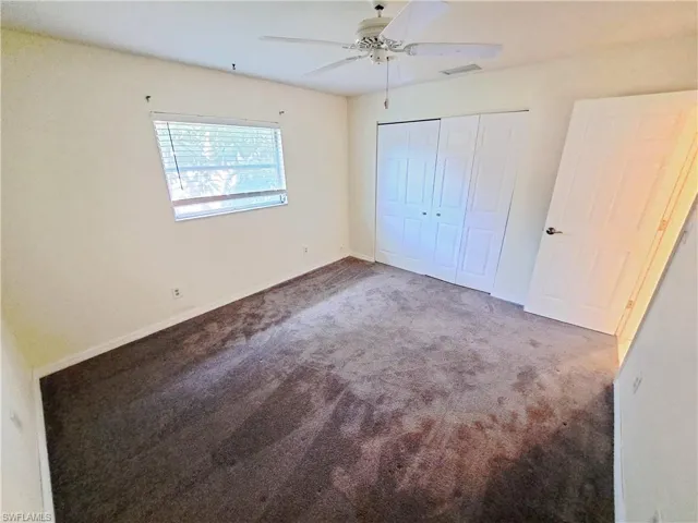 Unfurnished bedroom with carpet floors, a closet, and ceiling fan
