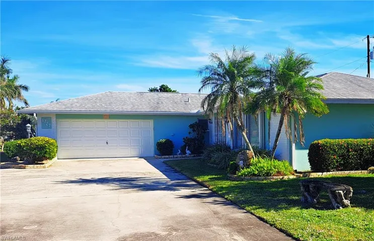 View of front of house with driveway and an attached garage