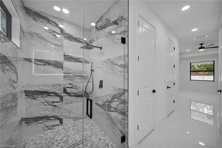 Bathroom with an enclosed shower and ceiling fan