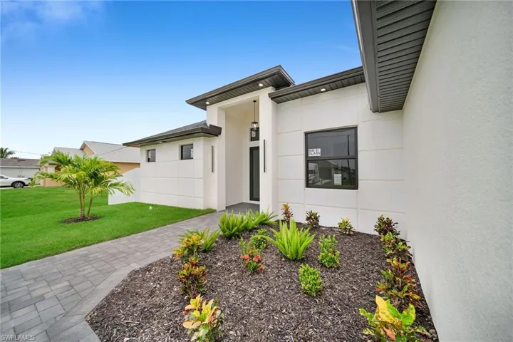 View of exterior entry featuring a yard