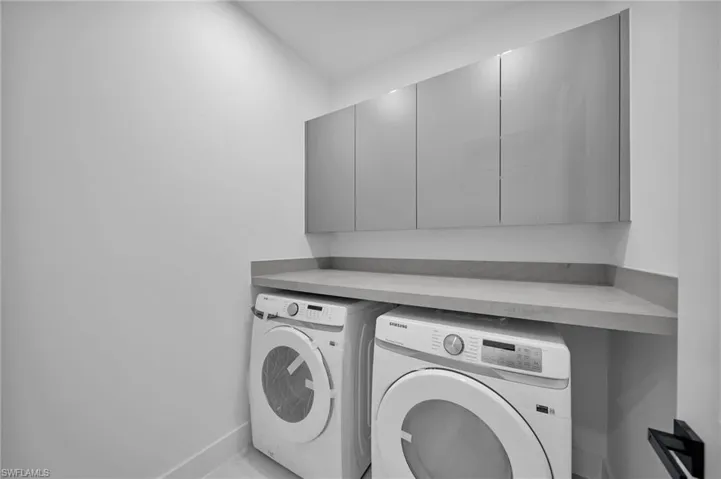 Clothes washing area with washing machine and clothes dryer and cabinets