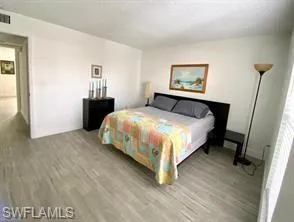 Bedroom with hardwood / wood-style flooring