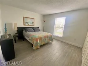 Bedroom featuring a textured ceiling and light wood-type flooring