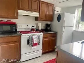 Kitchen featuring white appliances