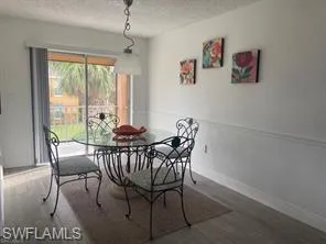 Dining room featuring hardwood / wood-style floors and a textured ceiling