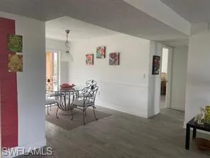 Dining space with dark wood-type flooring