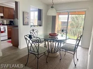 Dining room featuring wood-type flooring and plenty of natural light