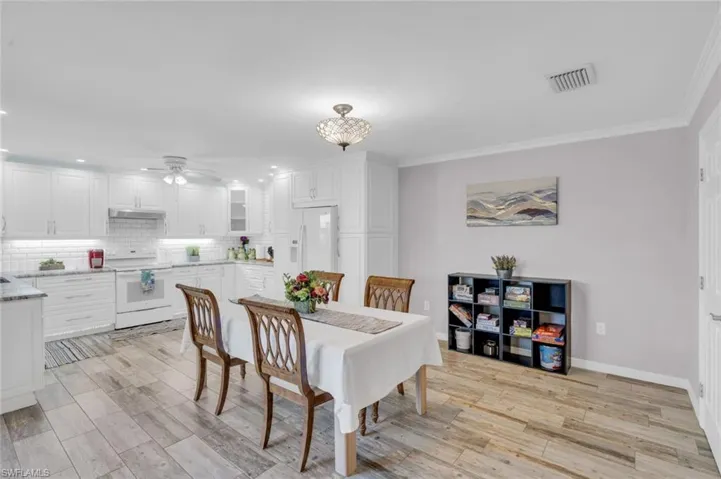 Dining room with a ceiling fan, ornamental molding, recessed lighting, and light wood finished floors