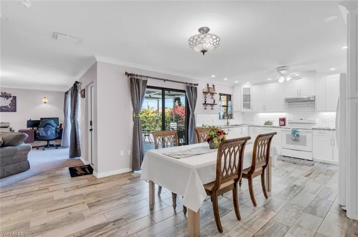 Dining space featuring a desk, crown molding, light wood-style floors, ceiling fan, and recessed lighting