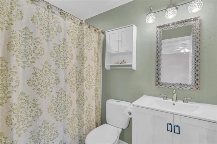 Full bathroom with vanity and curtained shower