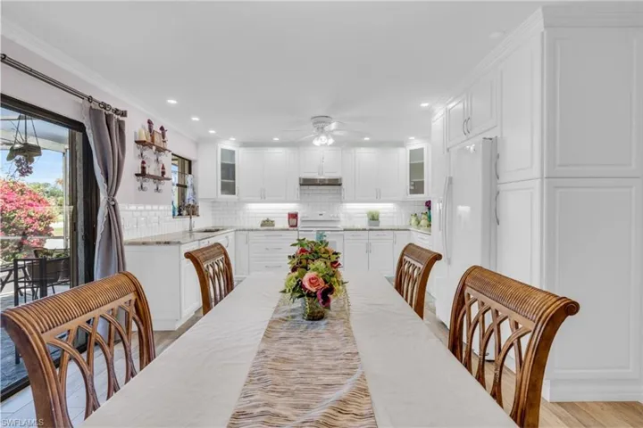 Dining space with a ceiling fan, recessed lighting, light wood-style flooring, and crown molding