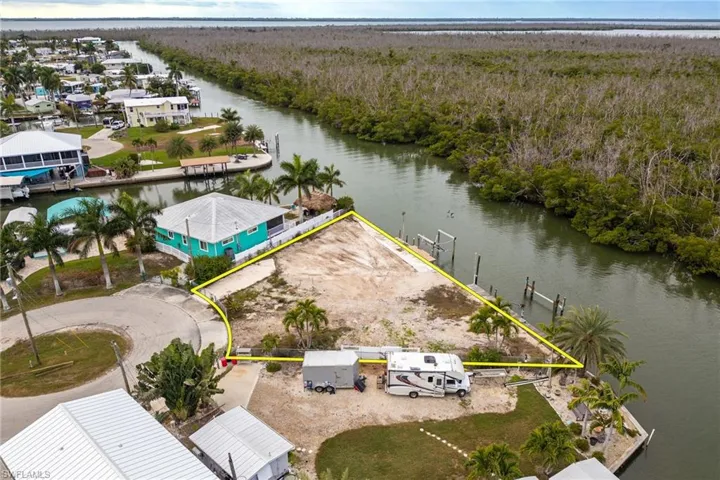 Aerial view of property and surrounding area featuring property parcel outlined and Cherry Canal