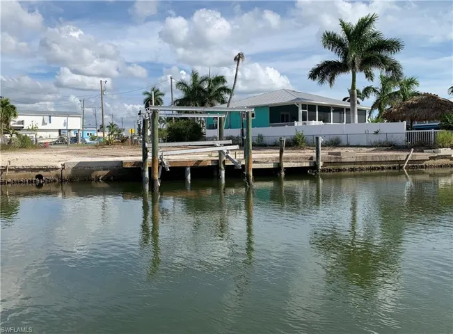 Dock area with a water view and boat lift