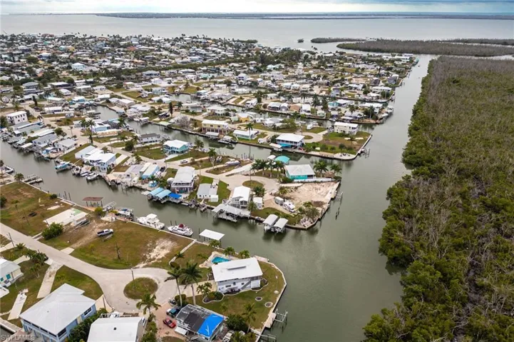 Aerial view of property and surrounding area featuring quick boating access to Pine Island Sound.
