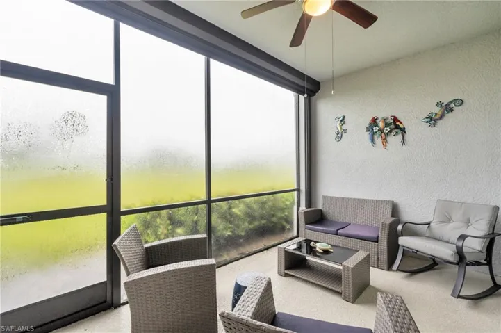 Sunroom with a wealth of natural light and ceiling fan
