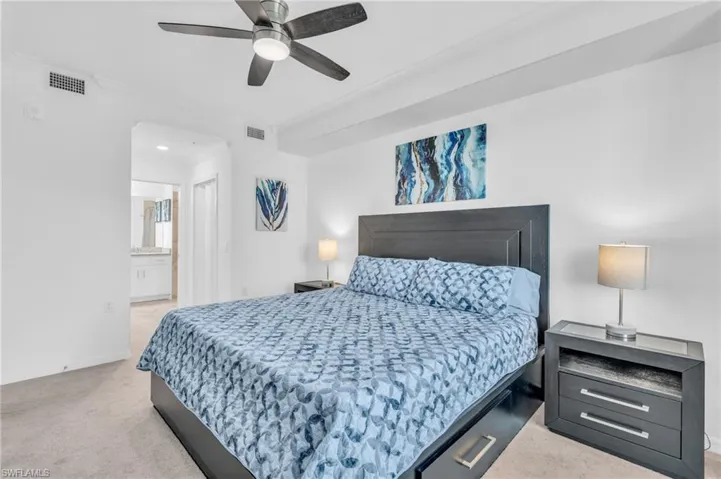 Bedroom featuring crown molding, light colored carpet, connected bathroom, and ceiling fan