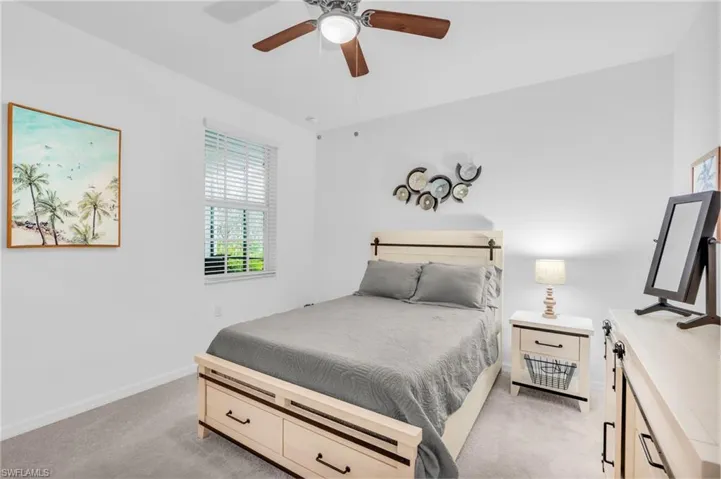 Bedroom featuring light carpet and ceiling fan