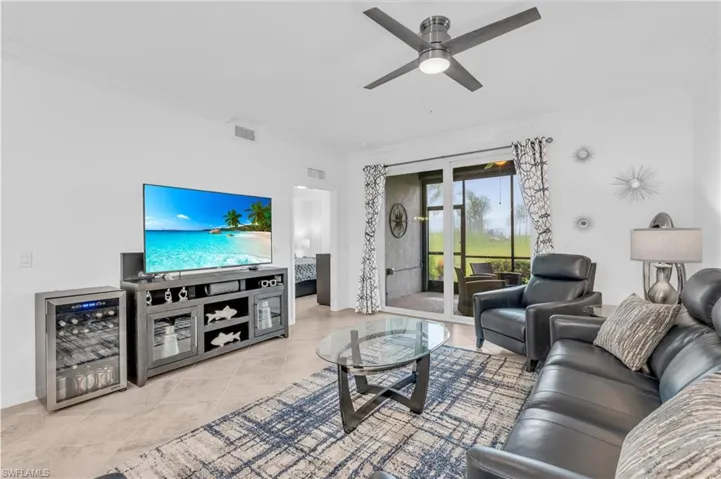 Tiled living room featuring ornamental molding, wine cooler, and ceiling fan