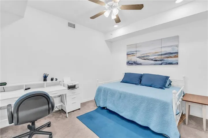 Carpeted bedroom with ceiling fan