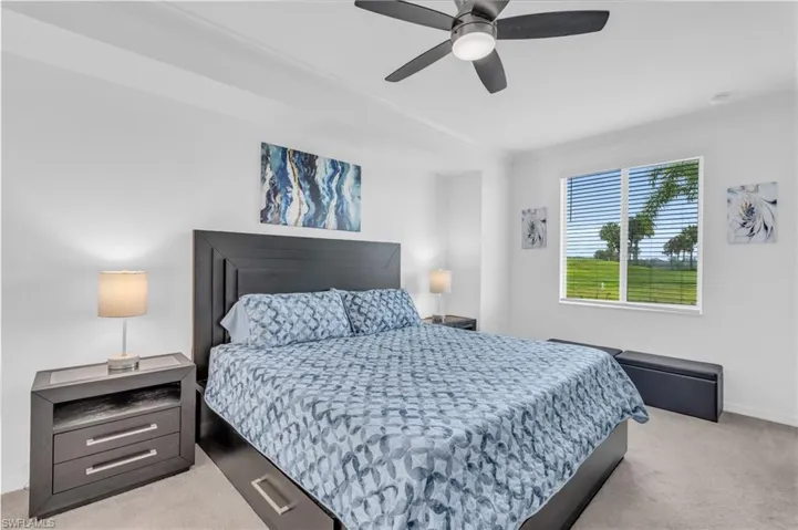 Carpeted bedroom featuring crown molding and ceiling fan