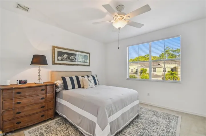 Bedroom featuring ceiling fan and light colored carpet