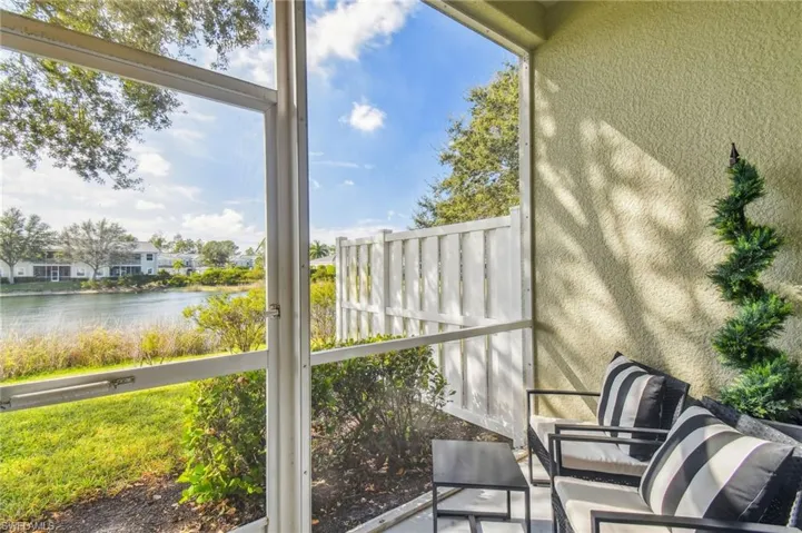 Sunroom / solarium featuring a water view