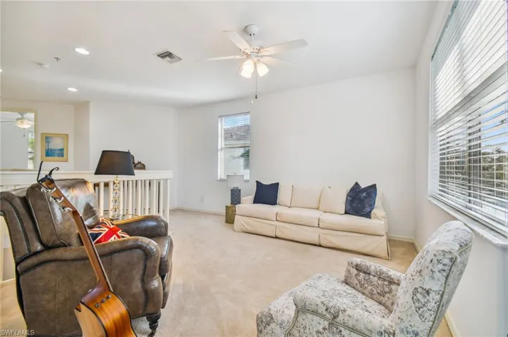2nd Floor Den with ceiling fan and light colored carpet