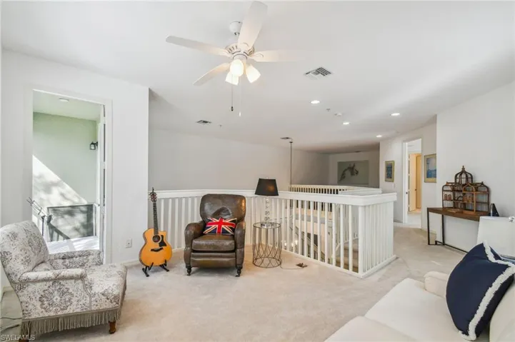 2nd Floor Den with ceiling fan and light colored carpet
