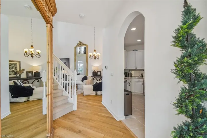 Hall with a notable chandelier and light hardwood / wood-style flooring