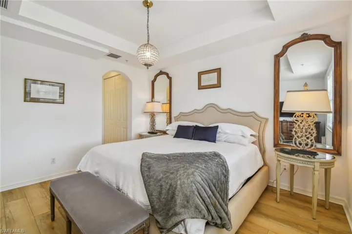 1st Floor Bedroom featuring light wood-type flooring and a raised ceiling