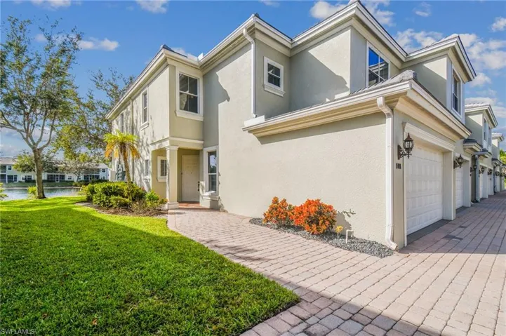 View of front of property with a garage and a front lawn