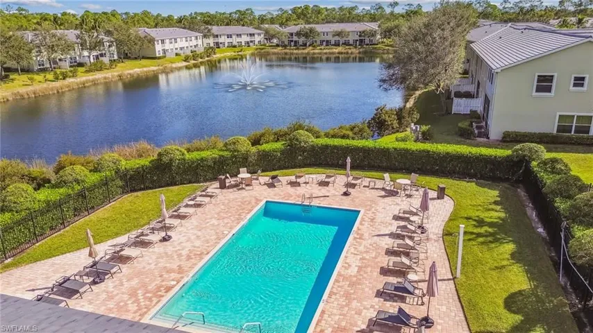 View of swimming pool featuring a water view, a yard, and a patio area