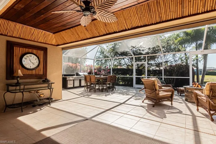 Sunroom / solarium featuring a wealth of natural light, ceiling fan, and wood ceiling