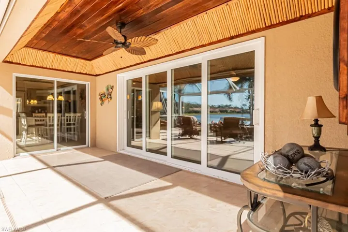 View of patio with ceiling fan and a water view
