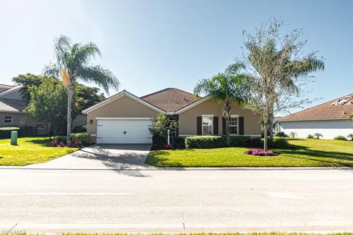 Ranch-style home featuring a garage and a front yard