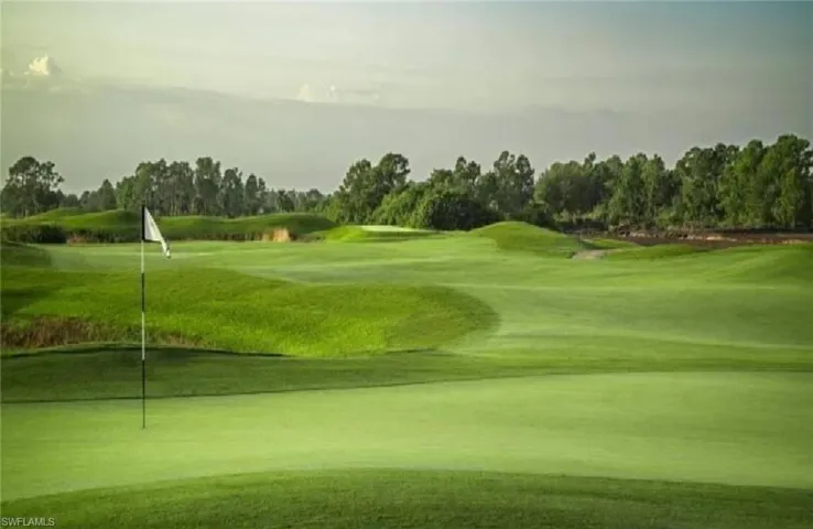 View of property's community featuring view of golf course and view of wooded area