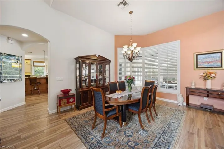 Dining room featuring light hardwood / wood-style tile  floors and a chandelier