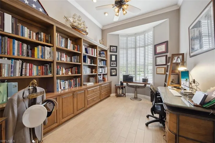 Office featuring crown molding, ceiling fan, and light hardwood / wood-style flooring
