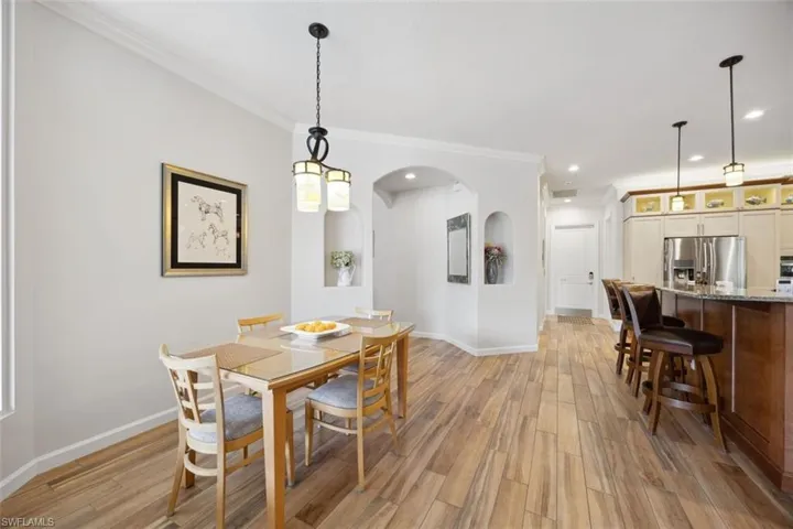 Dining area featuring light hardwood / wood-style floors and crown molding