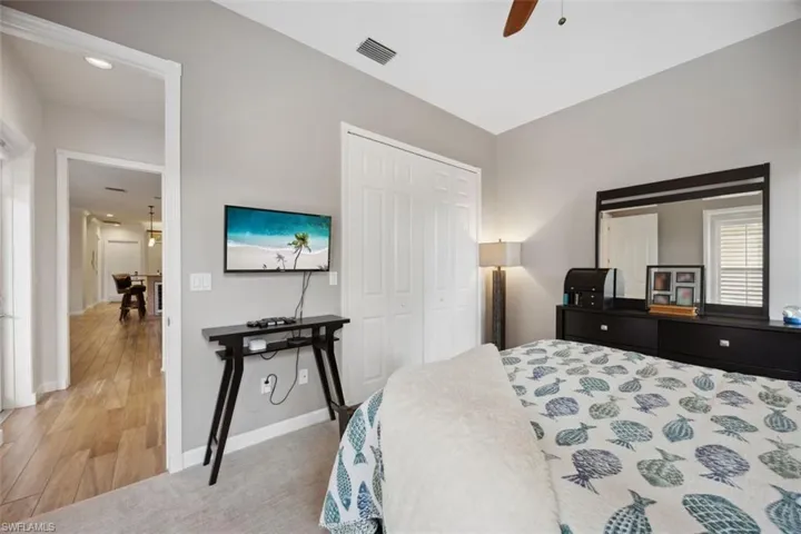 Bedroom with a closet, ceiling fan, and hardwood / wood-style flooring