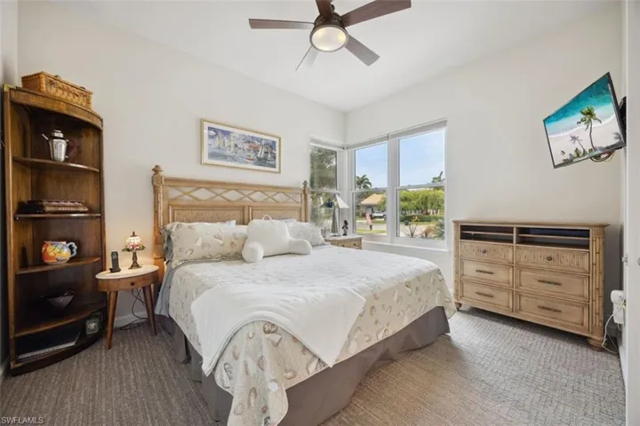 Carpeted bedroom with ceiling fan
