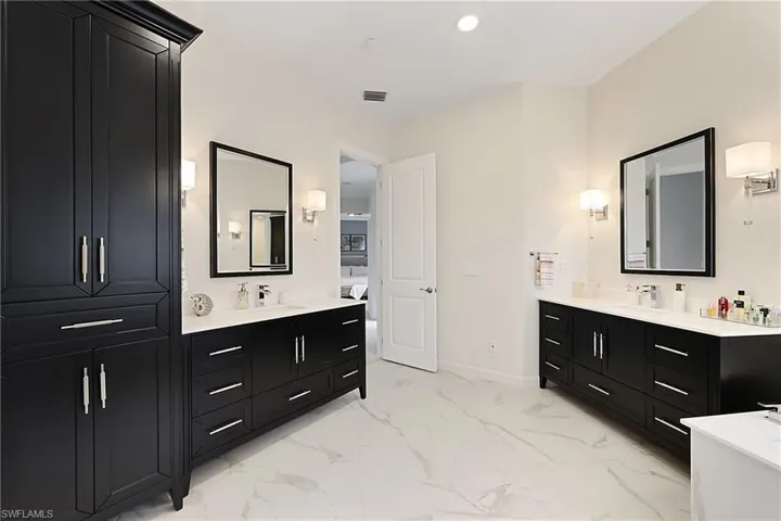 Primary Bathroom featuring dual vanities, updated 2024