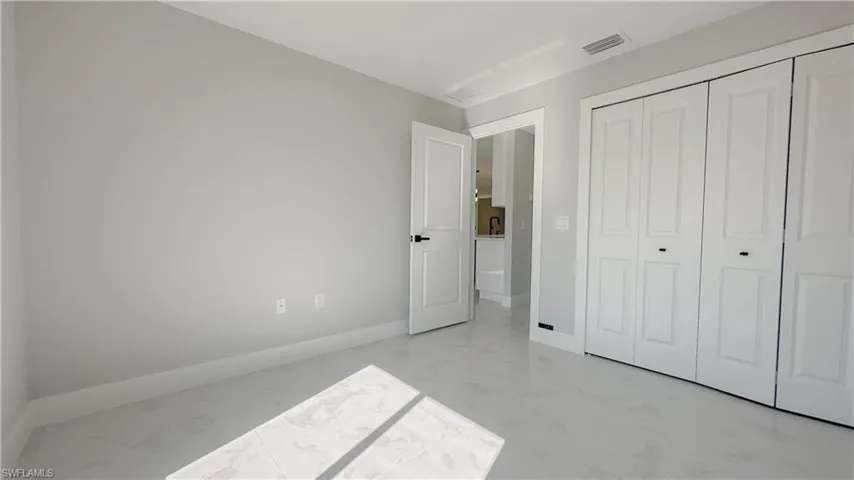 Unfurnished bedroom featuring a closet and light tile patterned floors
