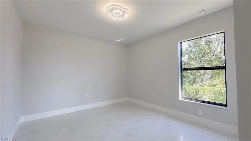 Unfurnished room with light tile patterned flooring and a healthy amount of sunlight
