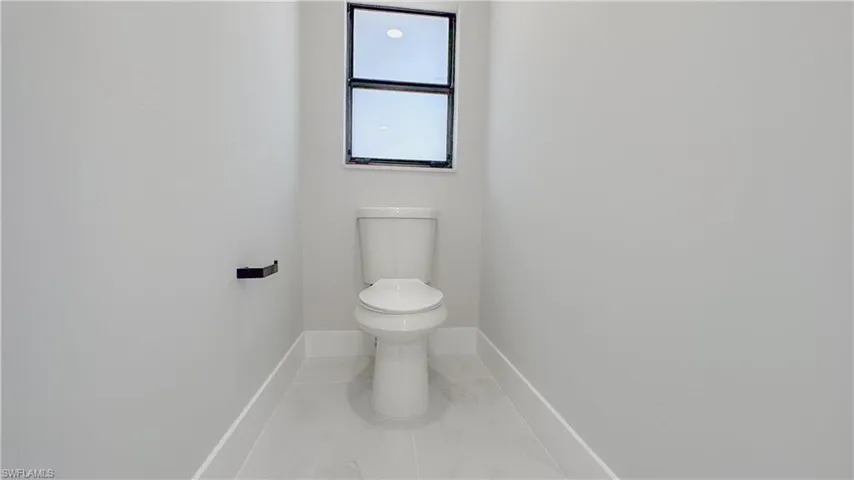 Bathroom featuring toilet and tile patterned floors